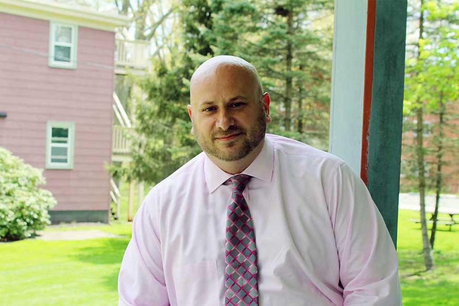 Jeremy Collins on the porch of Alumni Hall